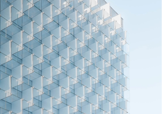 office-facade-repeated-glass-panels-blue-sky
